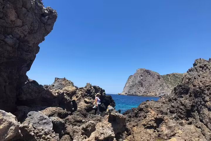 Visitors admire breathtaking coastal cliffs and blue seas on the Falassarna Beach tour from Chania.