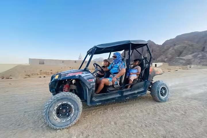 Family on 4-seater buggy safari in Sharm El Sheikh, off-road desert adventure with Sinai mountains