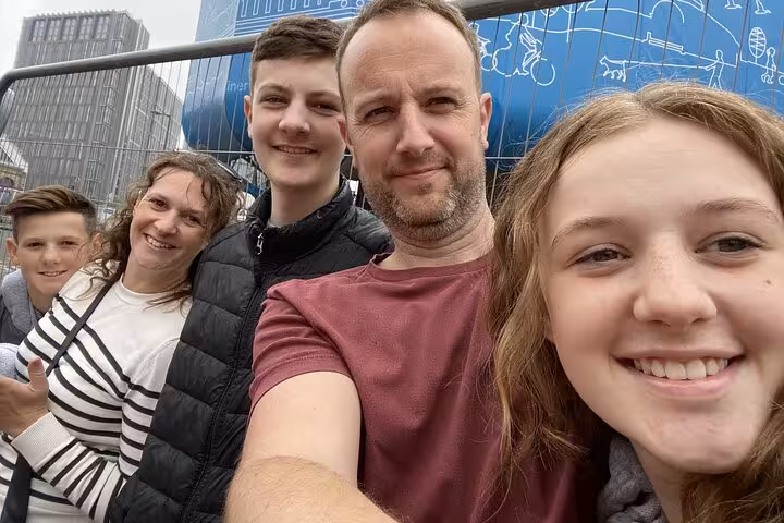 Family of five smiling for a selfie on the Beatles Walking Tour in Liverpool city centre