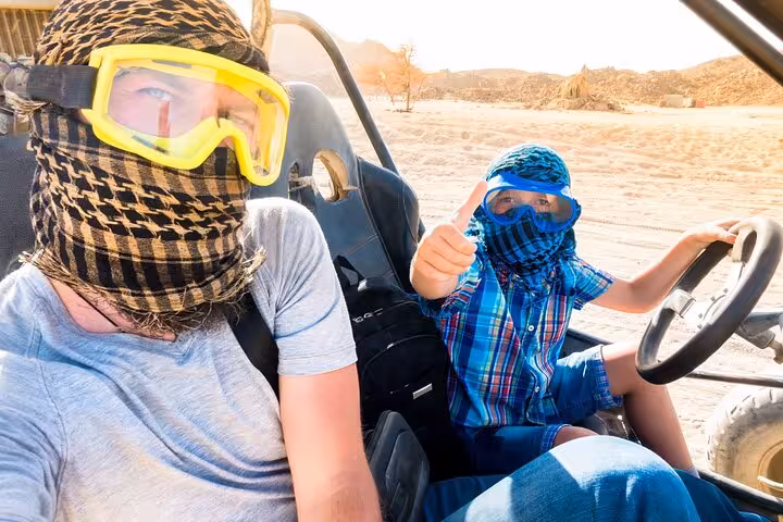 Family buggy ride in Hurghada desert, wearing goggles and scarves, sea and mountains adventure tour