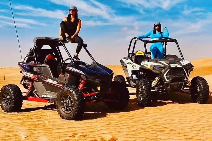 Two off-road family buggies parked on Sharm El Sheikh dunes for a desert safari and sand driving experience