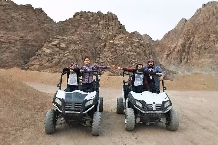Group family car buggies in Sharm El Sheikh, off-road safari photo with Sinai mountains backdrop