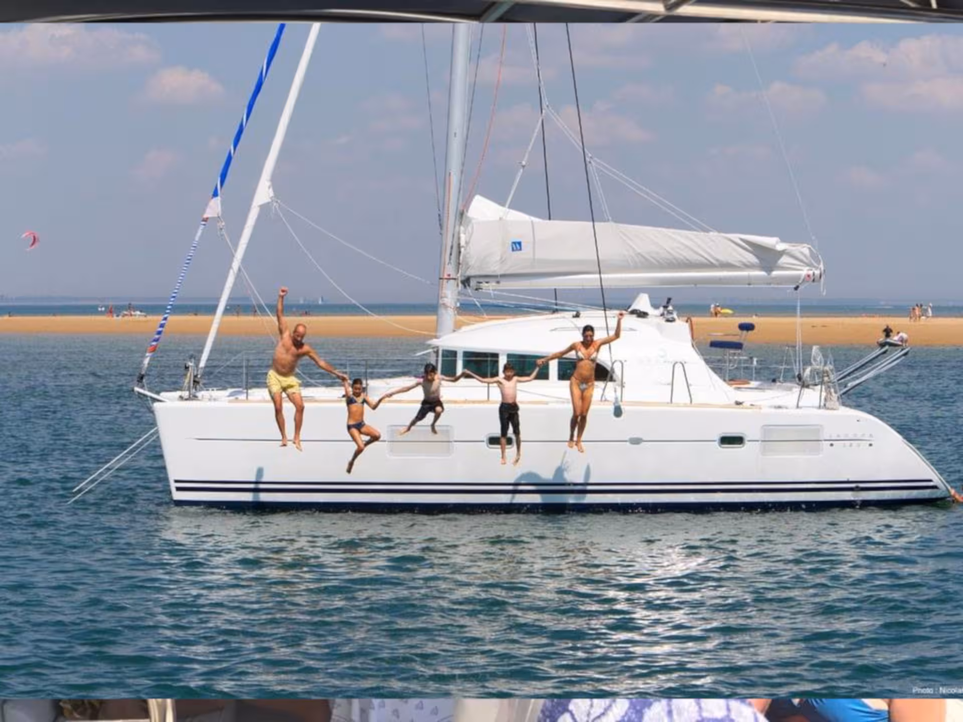 Family enjoying a fun dive off Catamaran Tenerè in La Maddalena Archipelago, highlighting adventure and leisure.