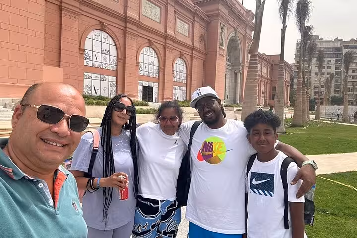 Family visiting the Egyptian Museum in Cairo on a 4-day private tour, exploring ancient artifacts with a guide