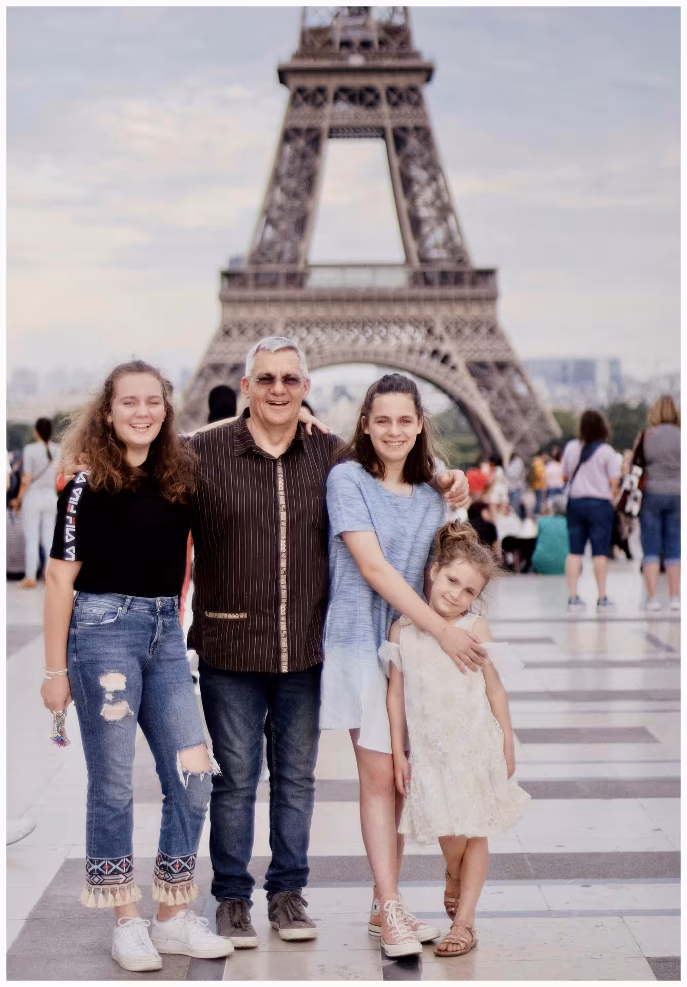 Family posing in front of the Eiffel Tower on the Trocadéro esplanade in Paris