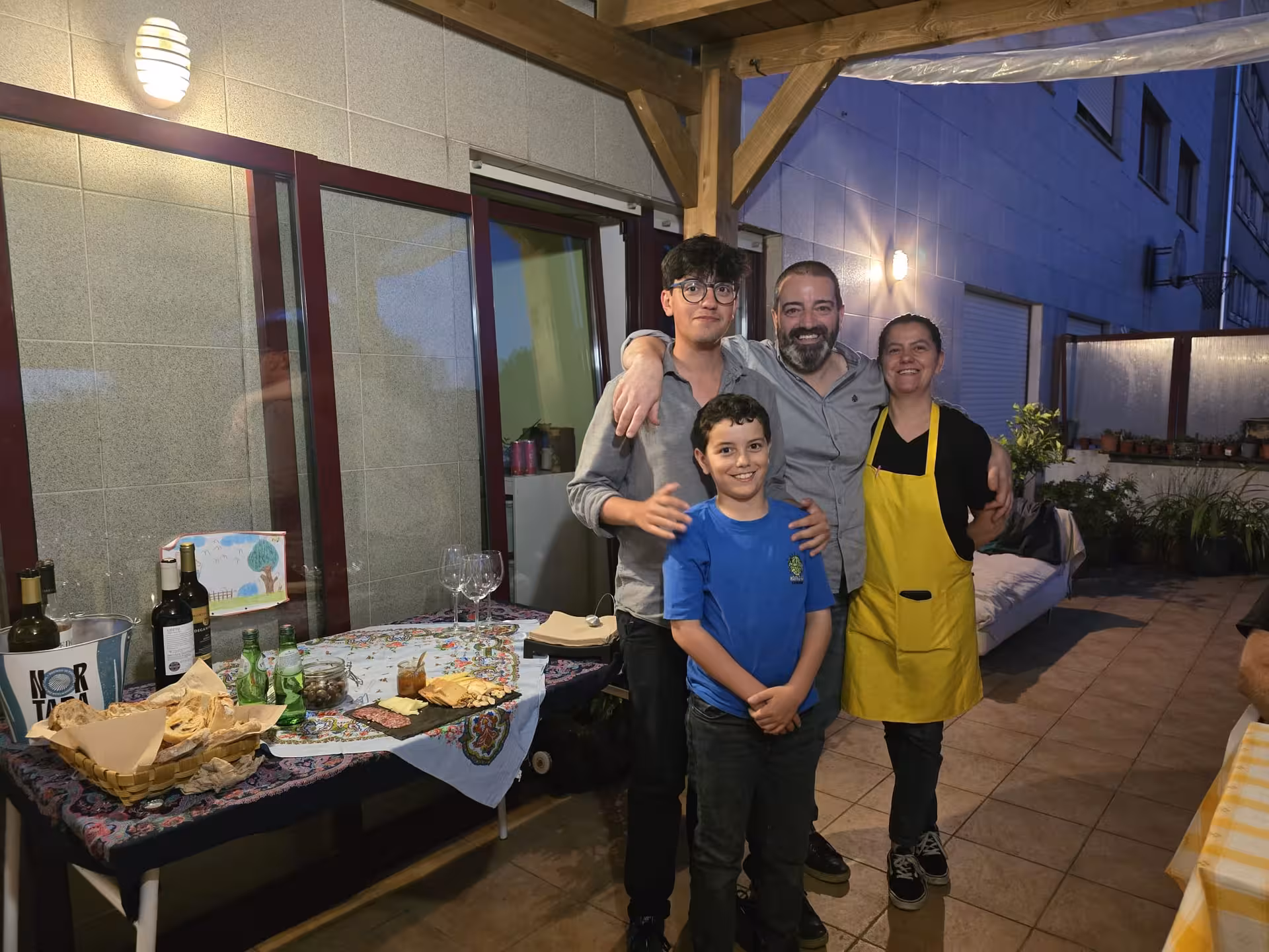 A family posing together at an outdoor dining setting in Porto, showcasing the Francesinha culinary experience.