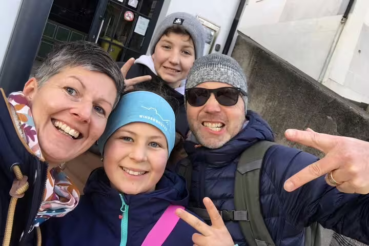 Family selfie on a Fribourg self-guided scavenger hunt tour, smiling outdoors while exploring city sights