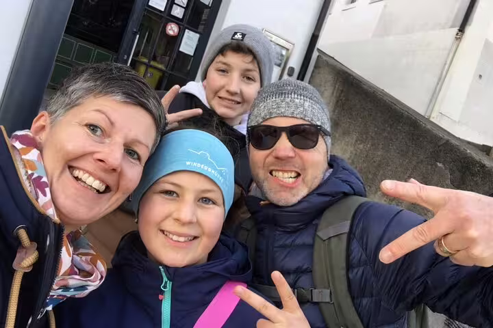 Family selfie on Fribourg scavenger hunt, smiling team ready for a self-guided city sights tour in Switzerland