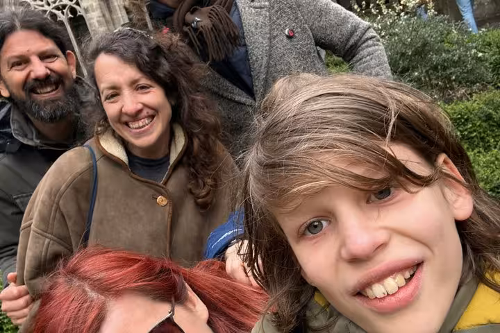 Family group smiling outdoors during a walking tour in Utrecht medieval city center