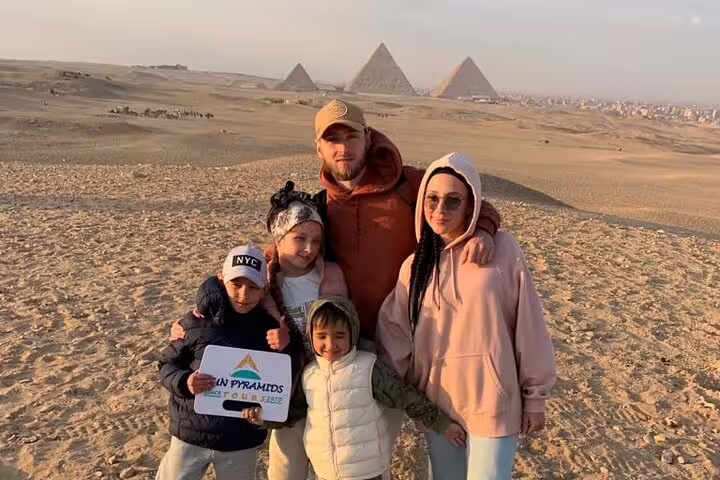 Family at Giza Pyramids viewpoint on private Cairo tour from Hurghada by air, Egypt day trip experience
