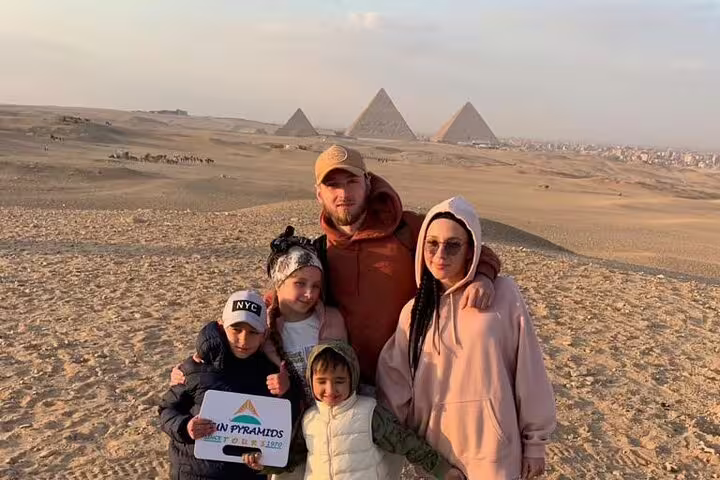 Family photo in Giza desert with Pyramids panorama, Cairo luxury tour to Pyramids and Sakkara