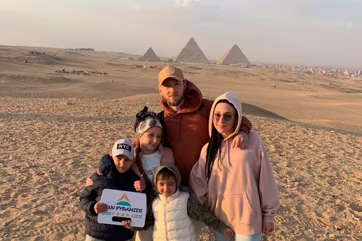 Family photo at Giza Pyramids on Cairo trip from Luxor by VIP first class overnight train tour