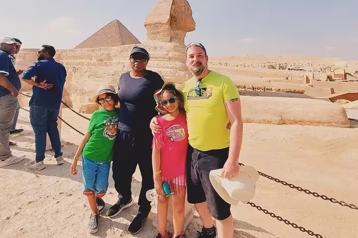 Family photo at the Great Sphinx and Giza Pyramids on a 3-day Cairo, Giza and Alexandria private tour
