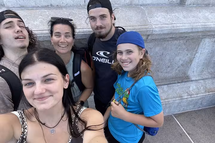 Group of five tourists smiling during a self-guided walking tour in Old Quebec City