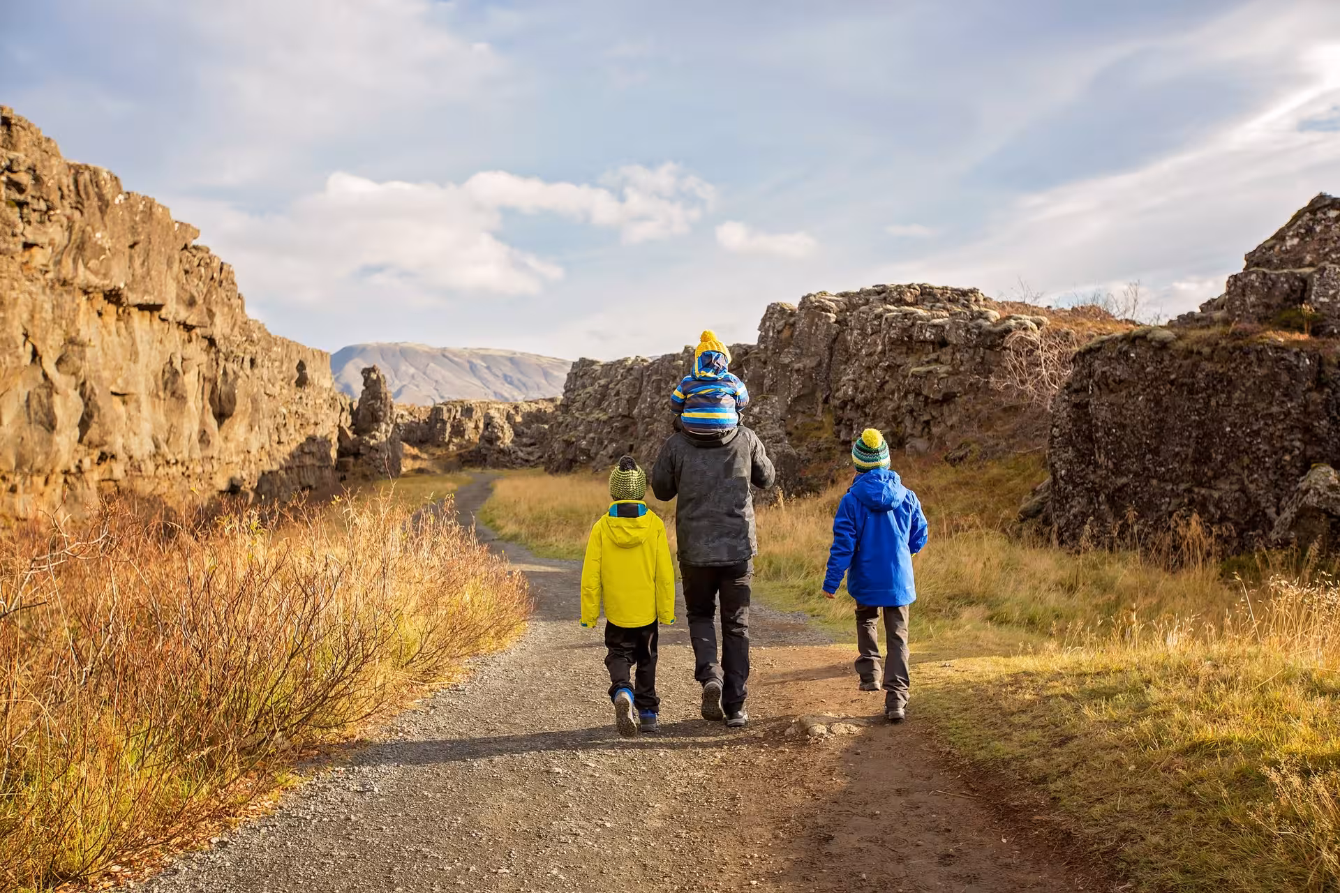 Family hiking through scenic Þingvellir National Park during a 5-day Iceland stopover tour.