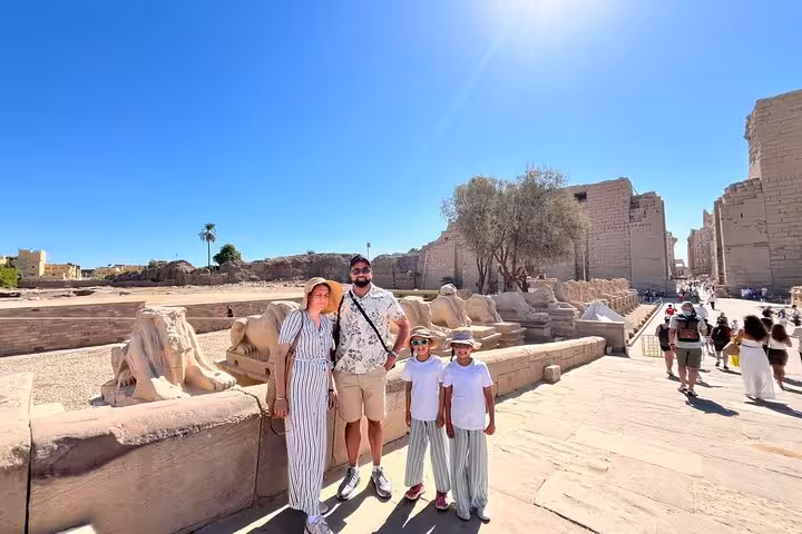 Family at Luxor Temple avenue of sphinxes on small group Cairo to Luxor flight tour, Tutankhamun option