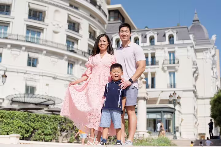Family enjoying a private photoshoot in front of a historic building in Cannes, perfect for capturing vacation memories.