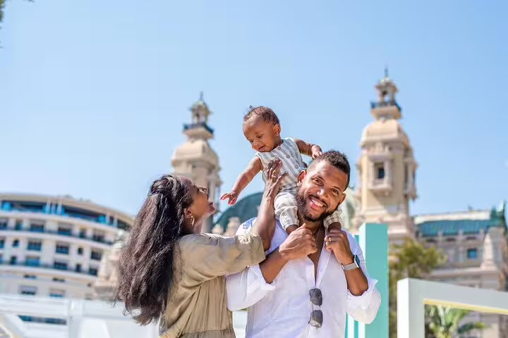 Family enjoying a sunny day in Cannes with iconic architecture as the backdrop during a professional photoshoot.