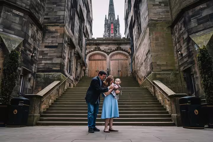 Parents with a child on an elegant staircase near Edinburgh Castle, perfect for a family photoshoot experience.