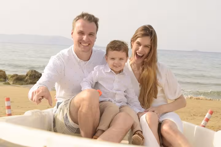 Smiling family with child enjoying a sunny day by the sea in a private photoshoot at The Port of Hersonissos.