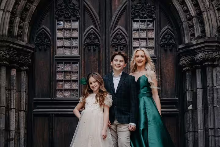 Family portrait at gothic church doors in Edinburgh, captured on a private photoshoot with professional photographer