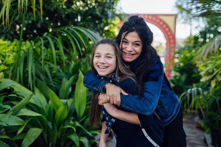 Family portrait in Monaco gardens on a private tour with personal travel photographer, candid hug moment