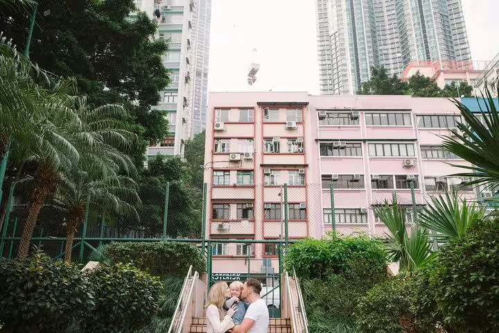 Family portrait on city steps with tropical greenery, shot by personal travel photographer tour in Singapore