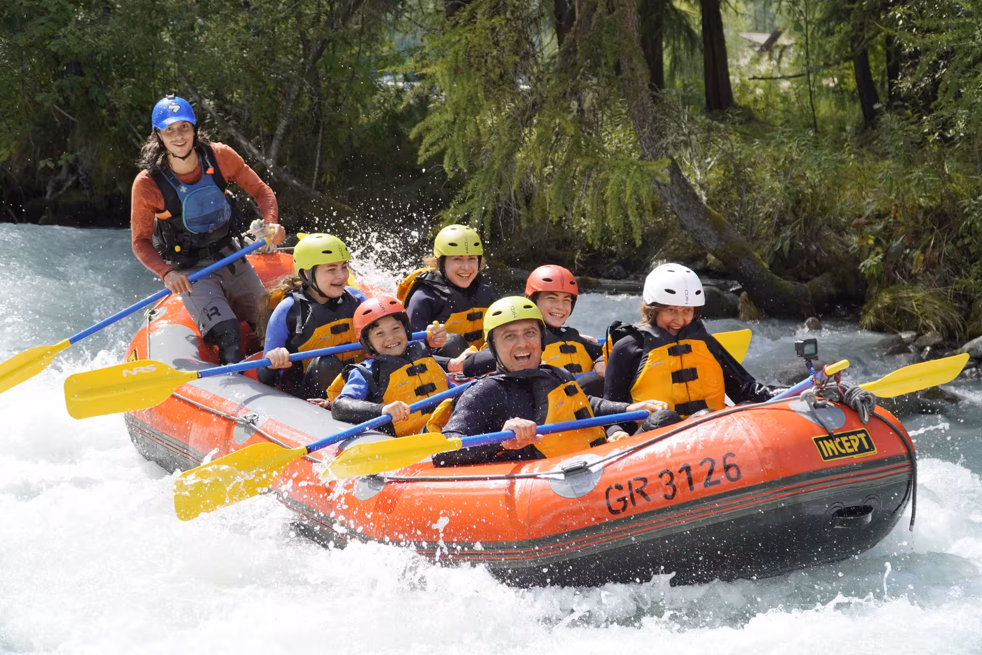 Happy family enjoying a thrilling rafting experience on the lively Simme River, ideal for all ages.