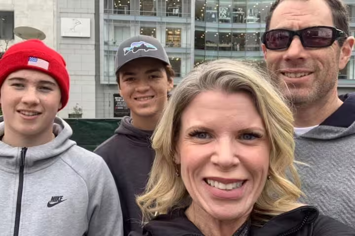 Family of four smiling during self-guided walking tour in San Francisco outdoors