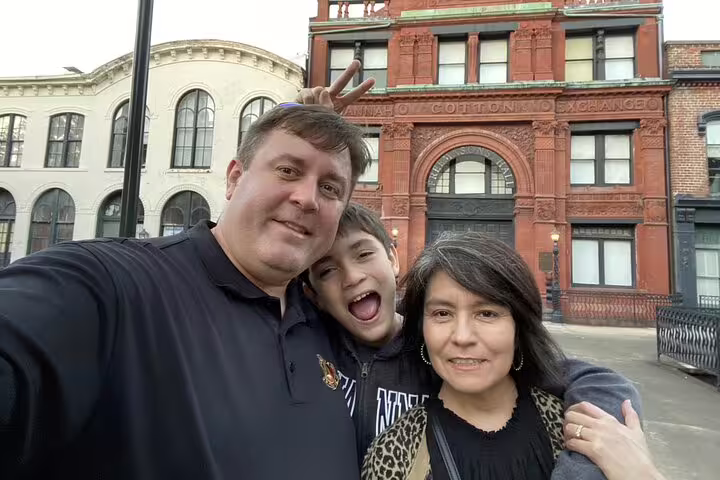 Family taking selfie in front of Savannah Cotton Exchange building on Savannah Waterfront