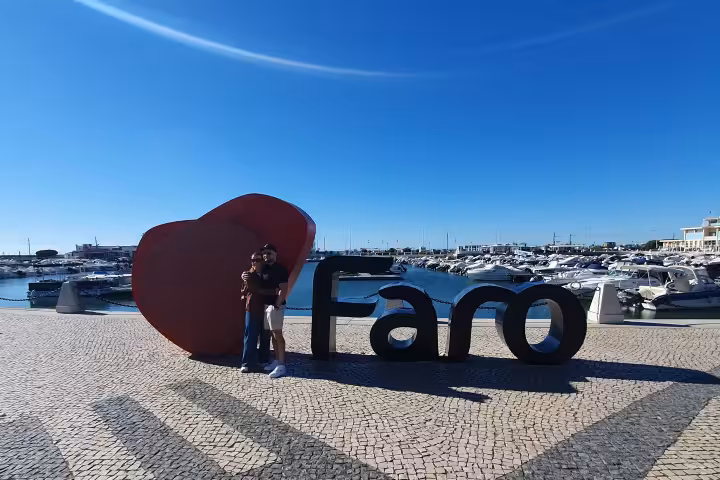 Scenic view of Faro marina with iconic heart sculpture, perfect for a memorable Algarve walking tour experience.