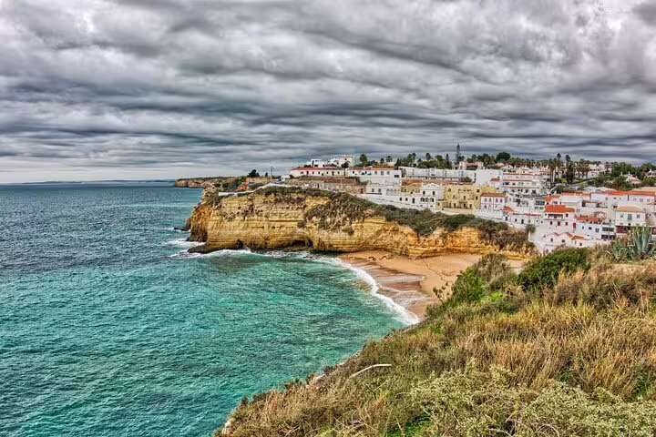 Algarve cliffside village and sandy cove on a Faro to Sagres private scenic coastal journey in Portugal