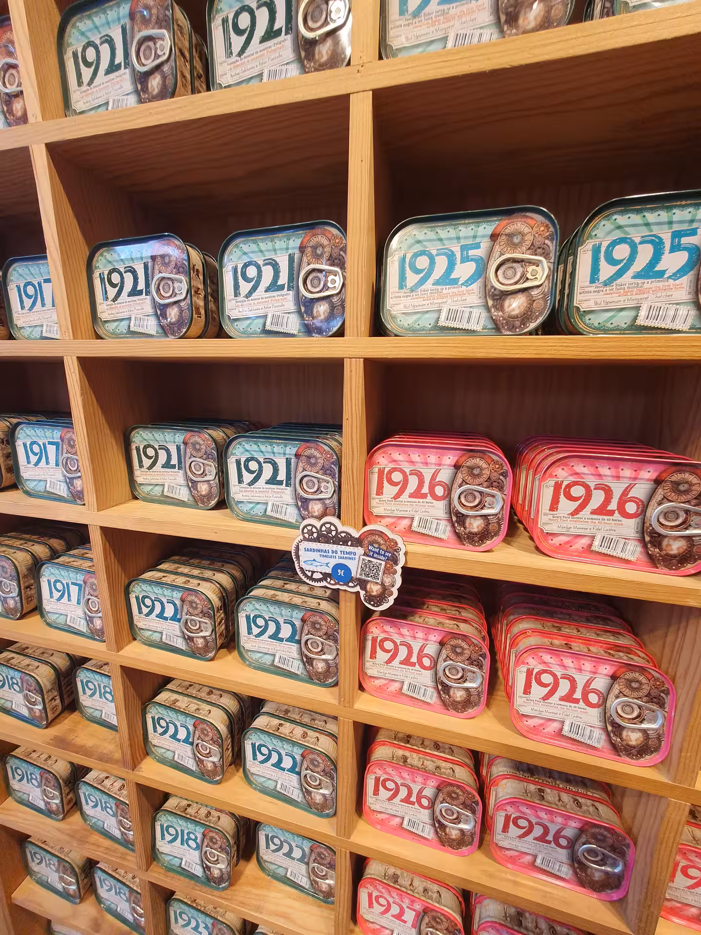 Colorful sardine can display in Faro shop, showcasing local culinary heritage on Algarve tour.