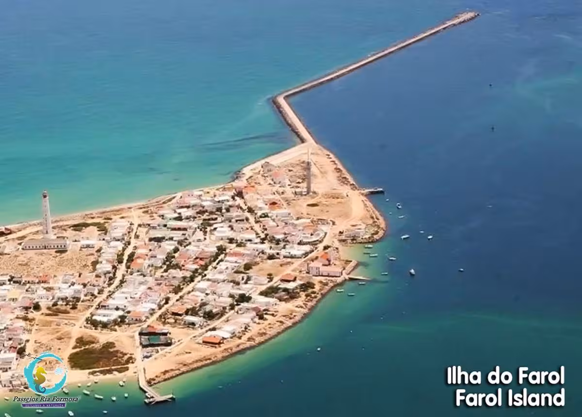 Aerial view of Farol Island lighthouse and village surrounded by turquoise Ria Formosa waters on Olhao boat tour