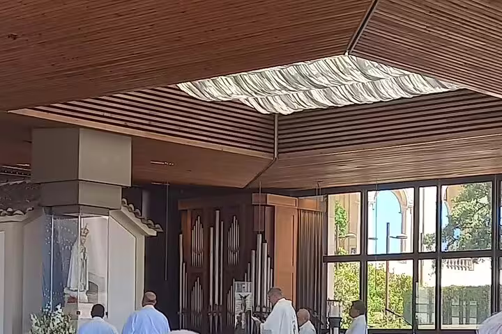 Priests conduct a service inside the Chapel of Apparitions in Fátima, part of the Fatima-Nazare-Obidos tour experience.