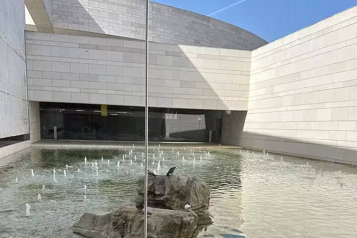 Modern courtyard with a tranquil water feature at Fátima, perfect for a serene moment during a small group day trip from Lisbon.