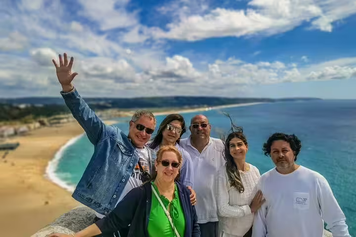 Group of tourists enjoying scenic ocean view on Fatima, Nazare, and Obidos full-day private tour from Lisbon.