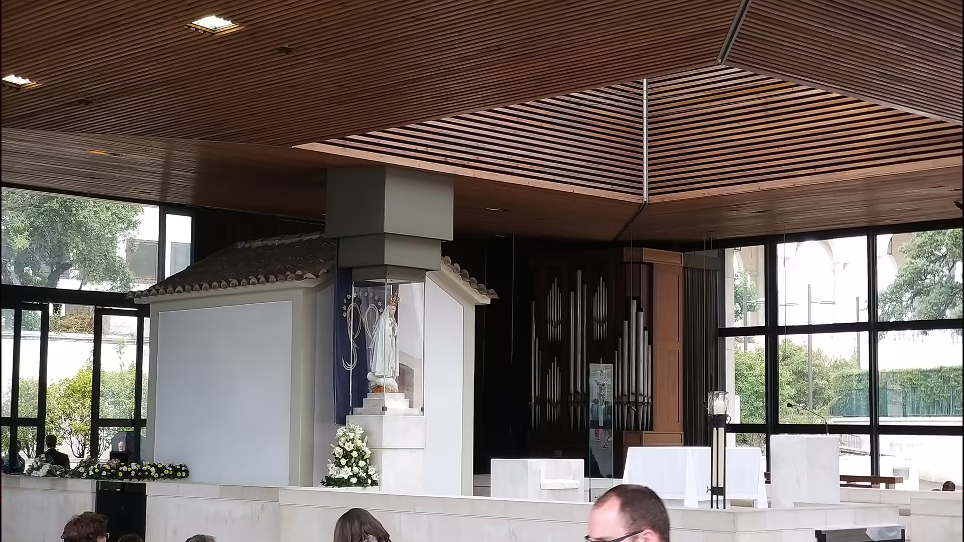 Interior view of Fátima Sanctuary chapel with altar and statue, highlighting serene atmosphere for private tour experience.