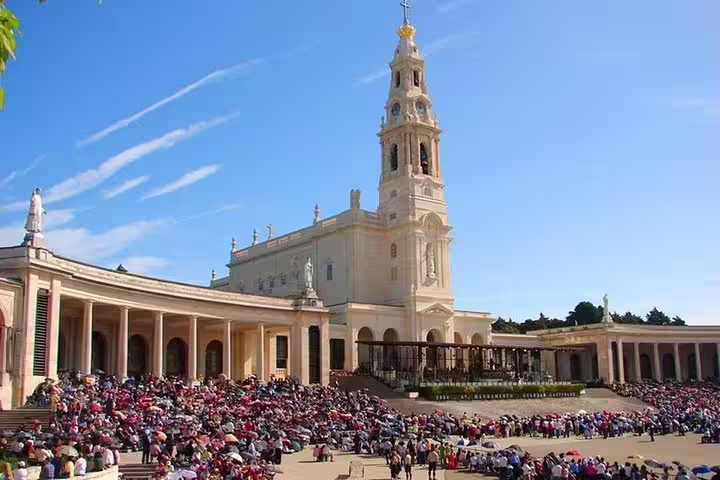 Crowds gather at the iconic Sanctuary of Fatima, a highlight of the Fatima, Nazare, and Obidos private full-day tour.