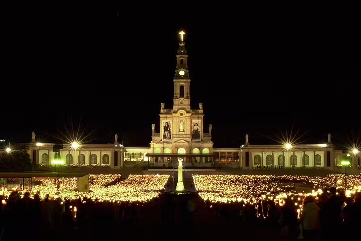 Night view of the illuminated Sanctuary of Our Lady of Fátima during a private half-day tour from Lisbon, Portugal.