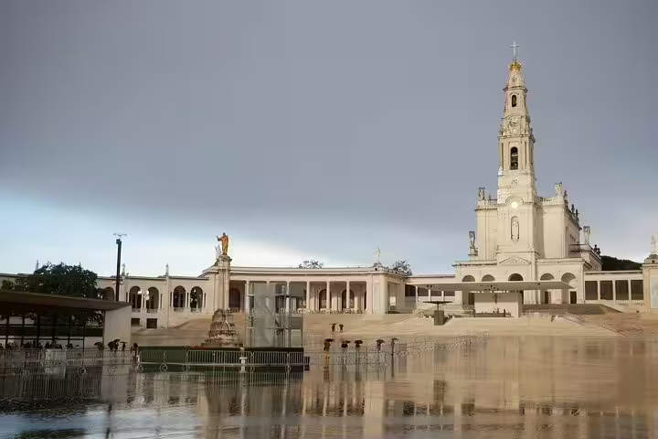The image showcases the stunning Fátima Sanctuary, a key highlight on the Fátima and Óbidos small group day tour in Portugal.