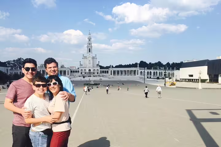 Visitors enjoying a sunny day at the Sanctuary of Our Lady of Fátima, a highlight of the private day tour to Fatima, Batalha, Nazaré, and Obidos.