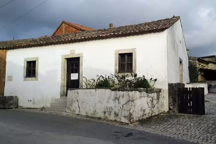Exterior of the Little Shepherds' House in Fatima, showcasing traditional Portuguese architecture, a key tour highlight.