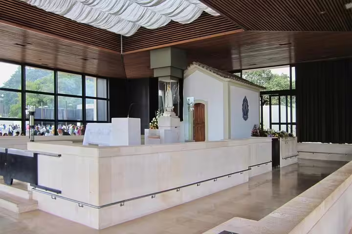 Interior view of the Fatima Shrine chapel, featuring a modern altar, popular on private tours from Porto.