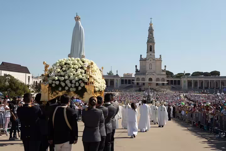 Procession at Fatima Shrine with a statue of Our Lady and the Basilica backdrop, offering a unique private visit.