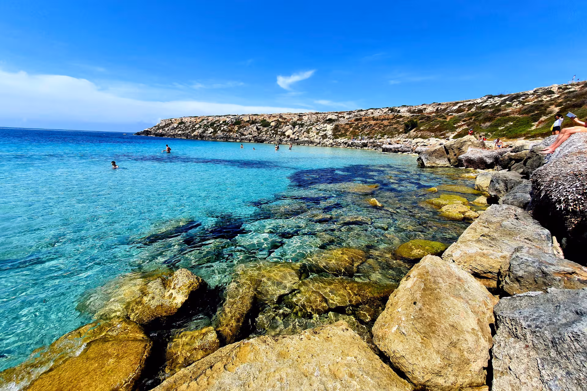 Crystal-clear rocky cove in Favignana, Egadi Islands, swimming stop on private boat tour from Trapani