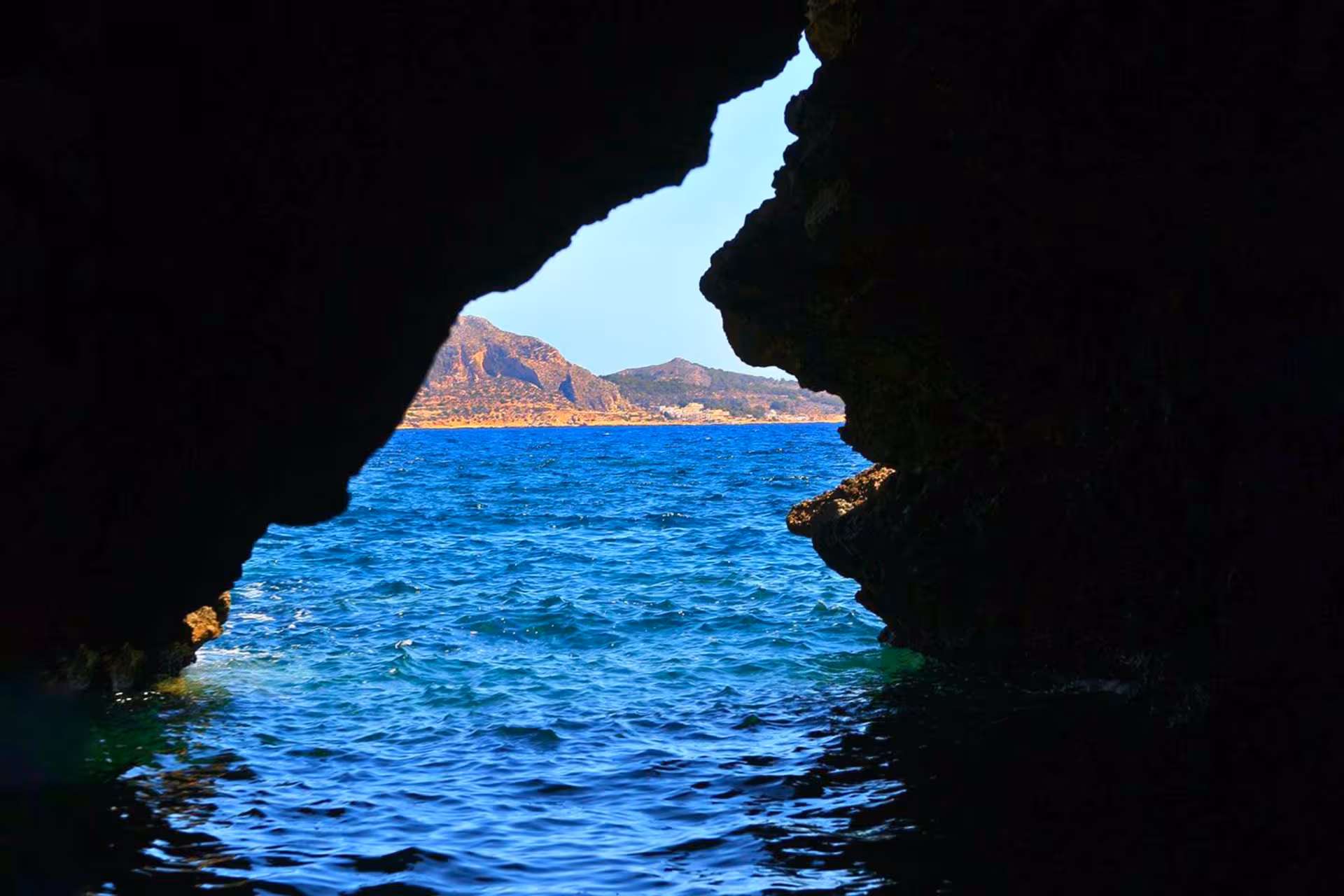 Sea cave opening on Favignana, Egadi Islands boat tour from Trapani with swim stops and lunch included