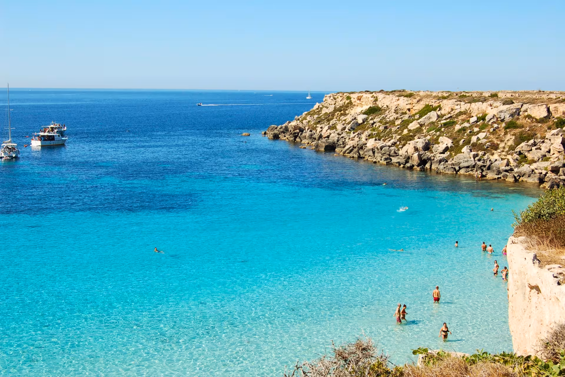 Favignana coastline and turquoise bay on Egadi Islands private boat excursion from Trapani to Levanzo with lunch