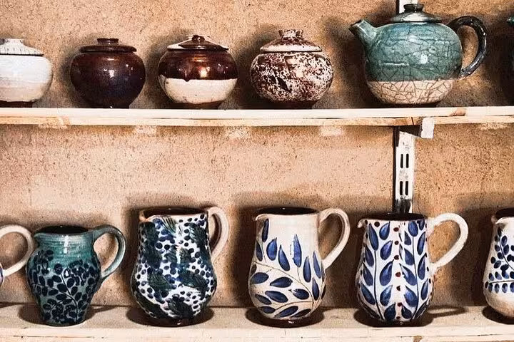 Handcrafted Fayoum pottery mugs and teapots on display, Cairo to Fayoum Oasis art and crafts tour stop