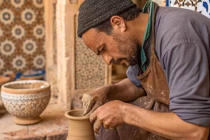 Fayoum Oasis potter shaping clay by hand in a local workshop, Cairo to Fayoum pottery art tour Egypt